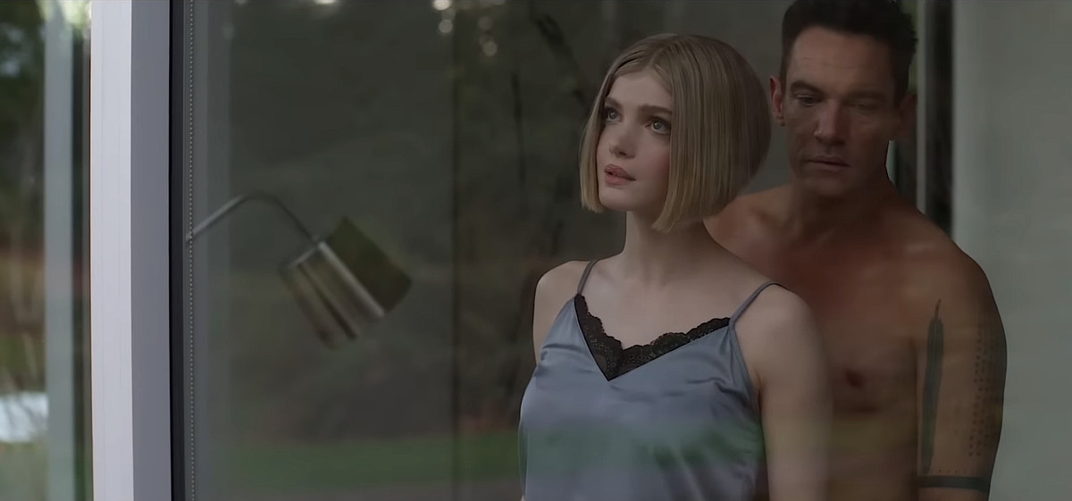 William (Jonathan Rhys Meyers) stands shirtless behind artificial companion Meredith (Elena Kampouris) in Wifelike